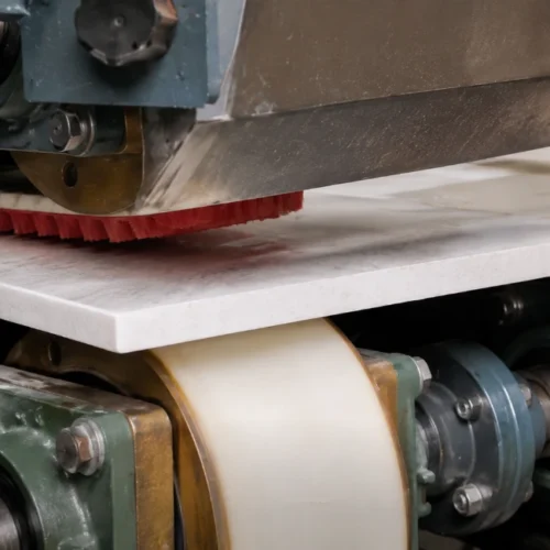 The stone edge polishing machine is in operation.